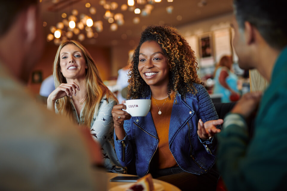 Costa Coffee customers enjoying coffee Costa Coffee customers enjoying coffee in café for brand marketing and lifestyle photography
