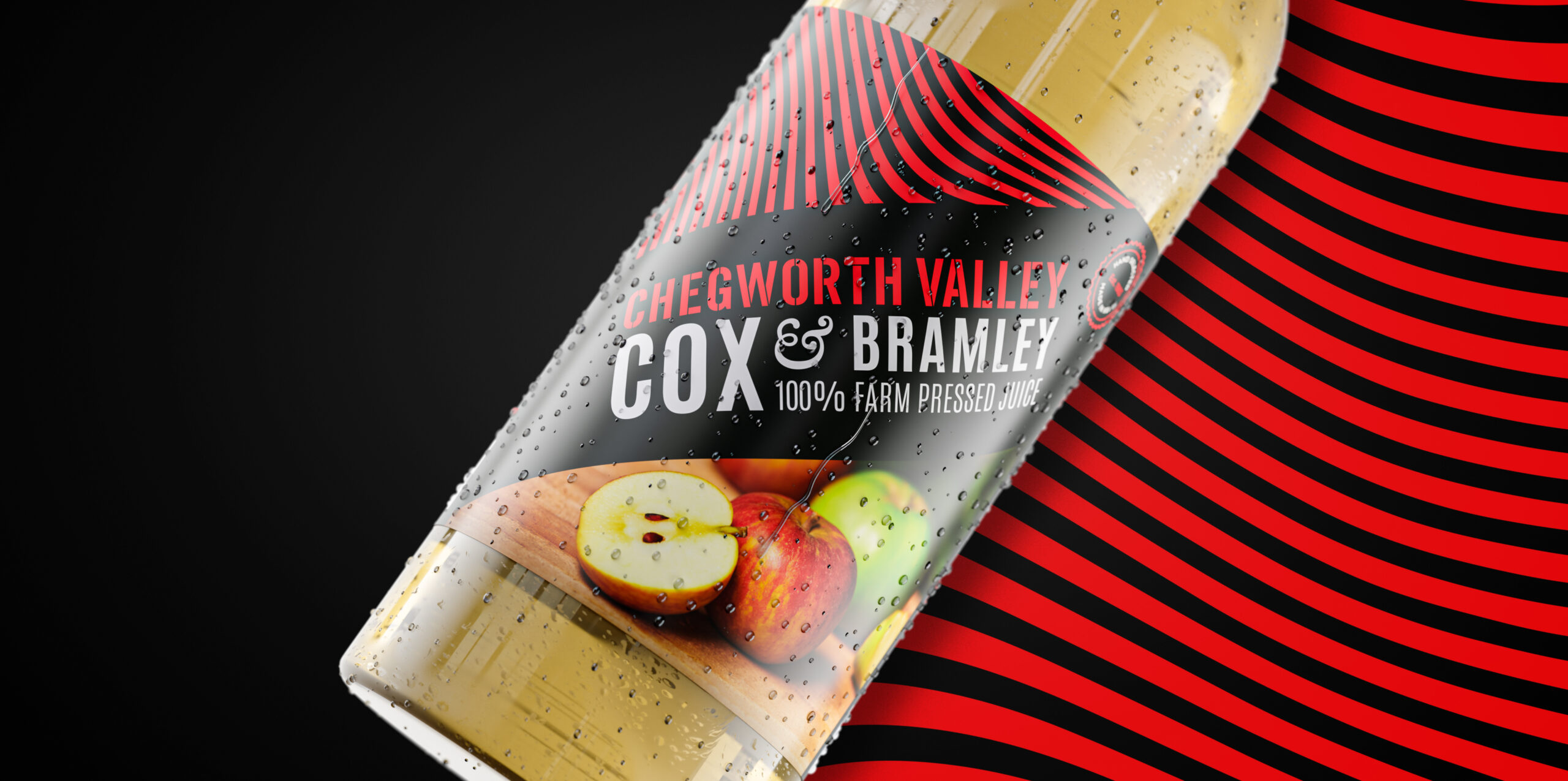 Chegworth Valley Cox & Bramley apple juice bottle with black and red label, water droplets on glass, set against a bold red and black striped background.