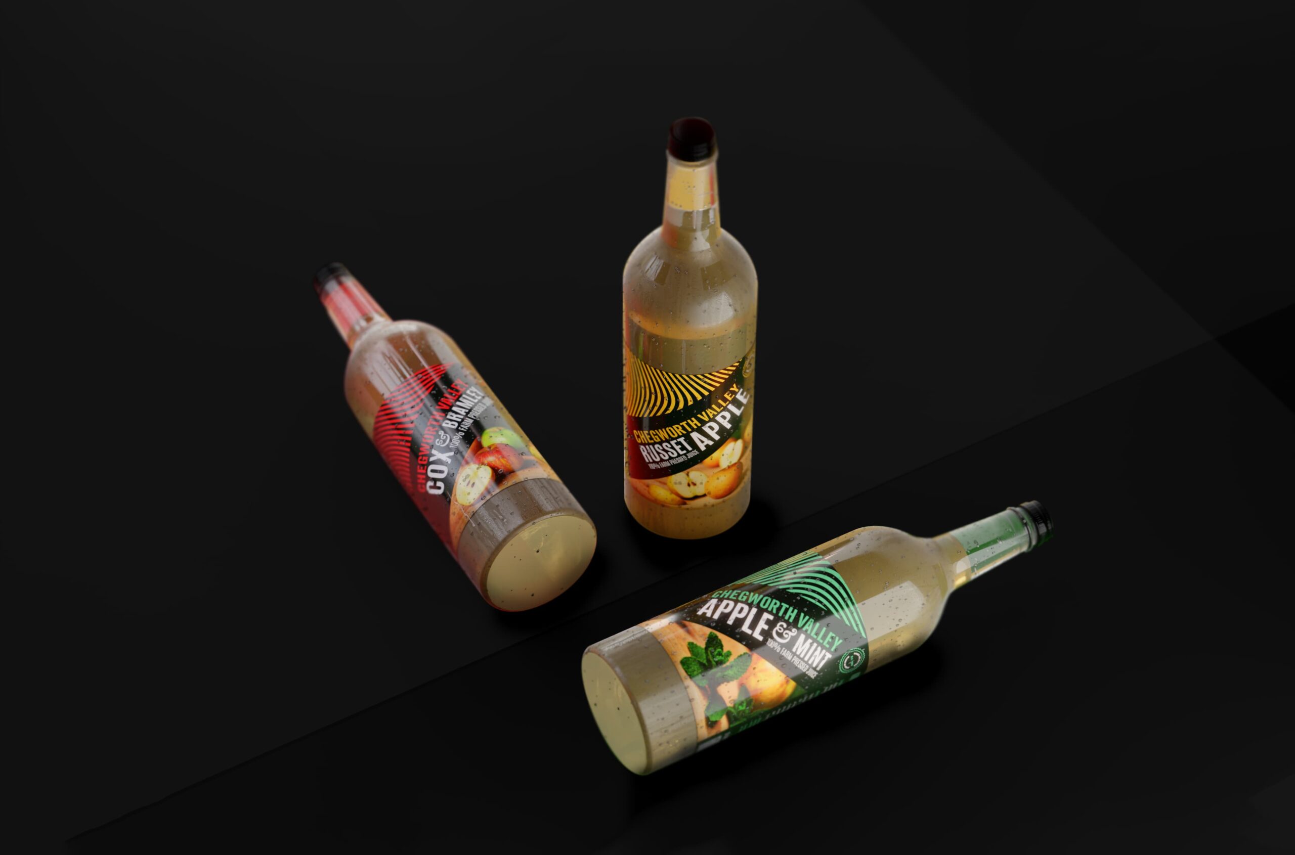 Chegworth Valley branded glass juice bottles showcasing apple, russet apple and apple & mint farm-pressed juices.