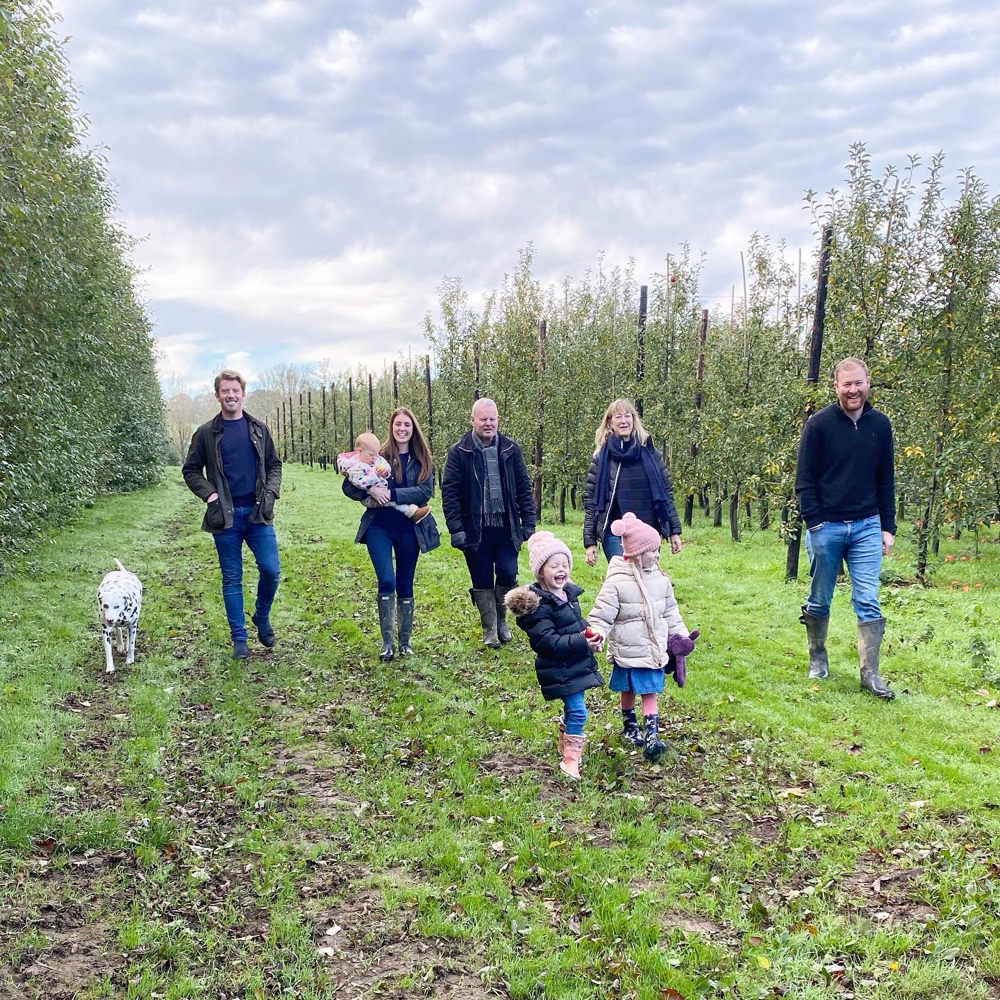 People walking through a green countryside pub garden in Kent, reflecting the rural setting and landscape associated with Chegworth Valley farm-pressed juices.
