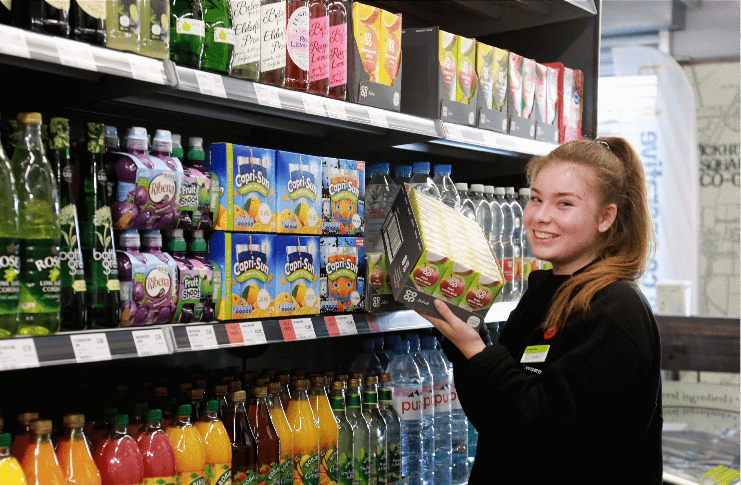 Southern Co-op staff stocking drinks supporting CRM customer relationship management and website design