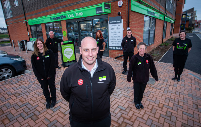 Southern Co-op store team outside retail branch, supporting CRM customer relationship management and local website design