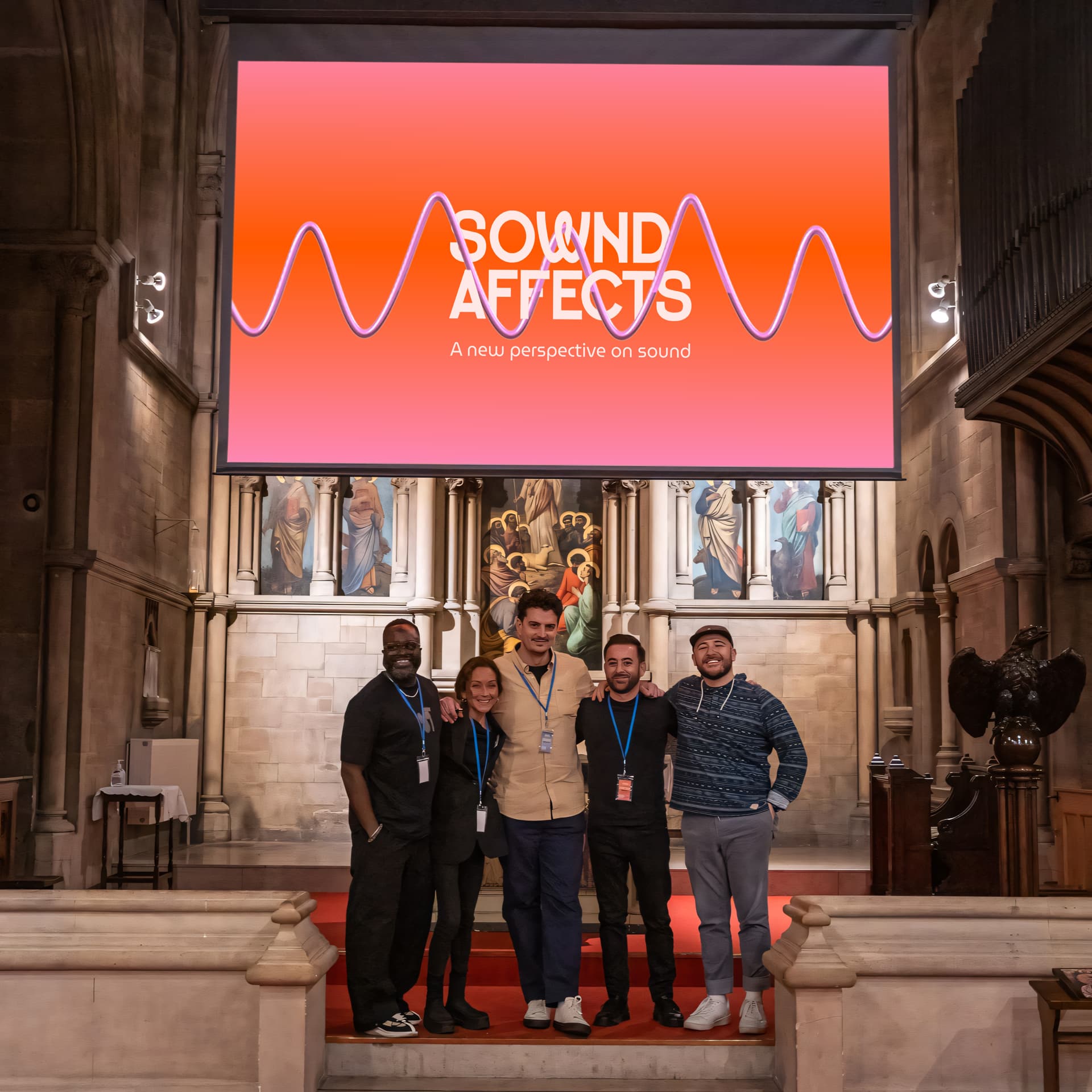 Sownd Affects event banner with sound wave branding above staff team standing inside a historic venue, representing inclusive sound design and sound awareness.