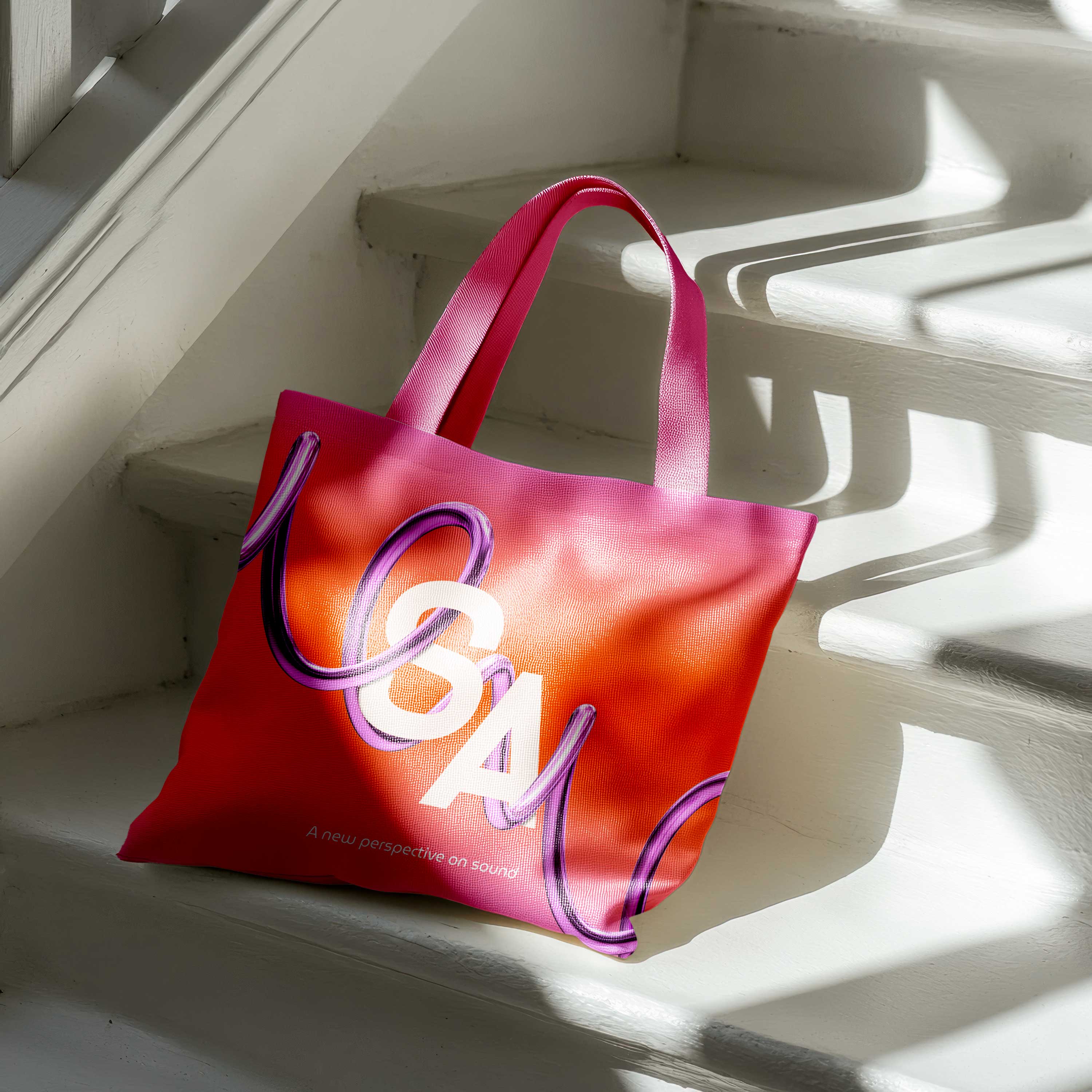 Sownd Affects branded tote bag with vibrant sound-inspired graphics, shown in natural light on steps.