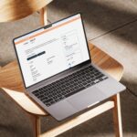 LawTech UK company profile for Agiloft on a laptop screen, displaying detailed brand information, areas of work, and contact details for legal contract management software.