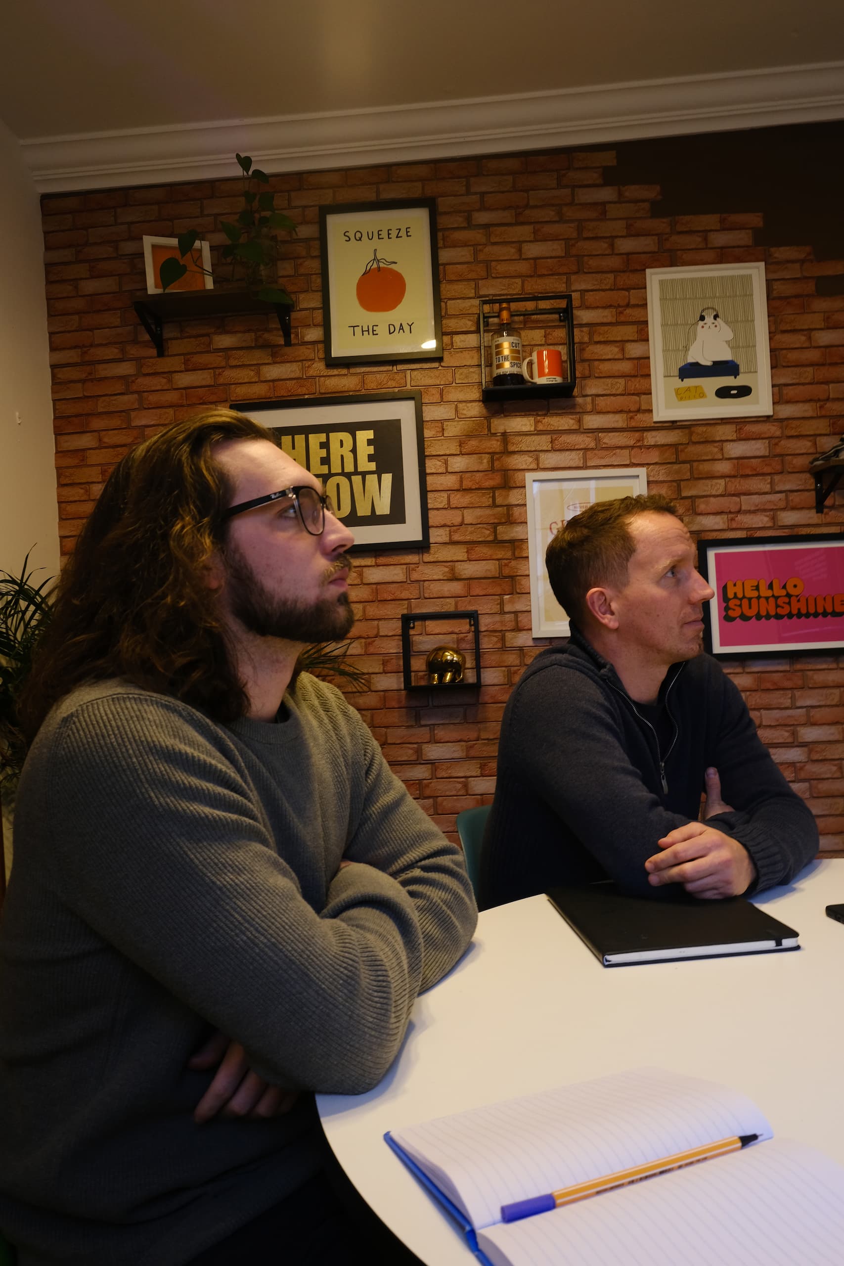 Website Design Catchup at Geobrand Offices Designer and managing director reviewing website design concepts in agency meeting room