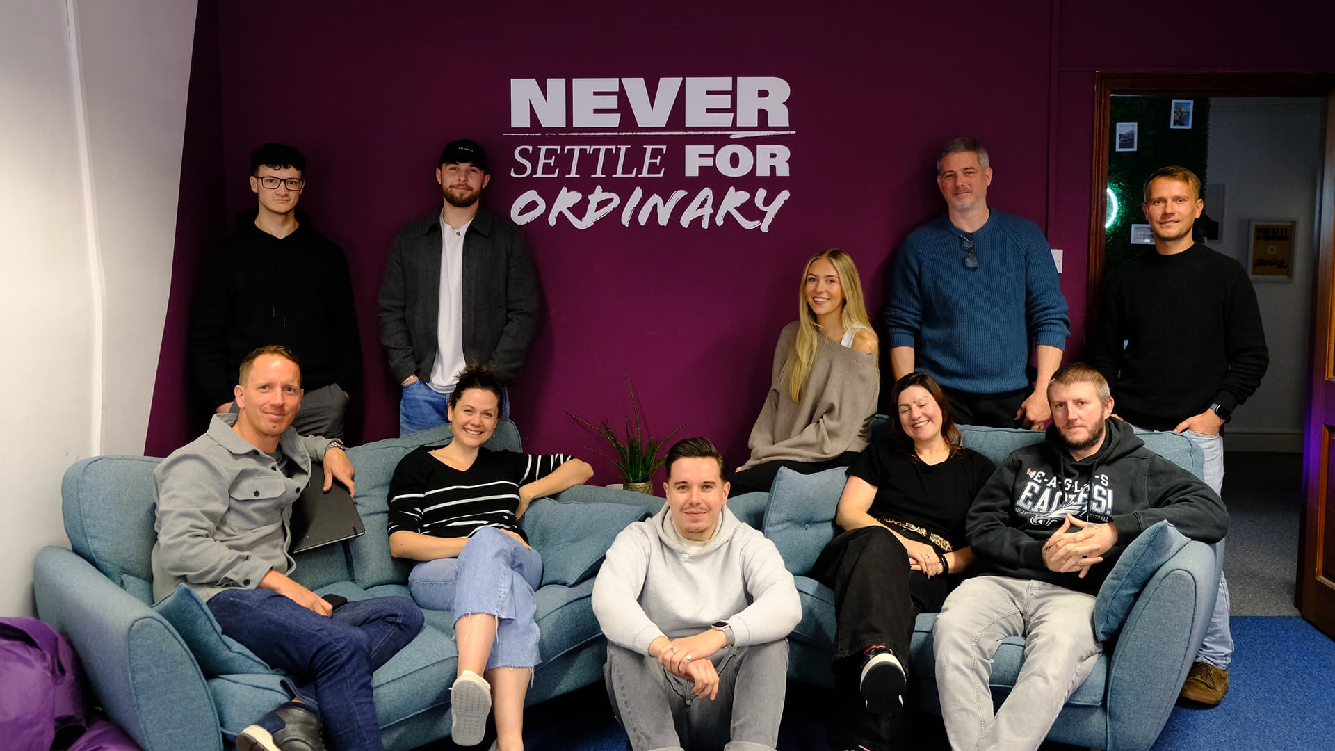 agency team in front of branding slogan for brand development