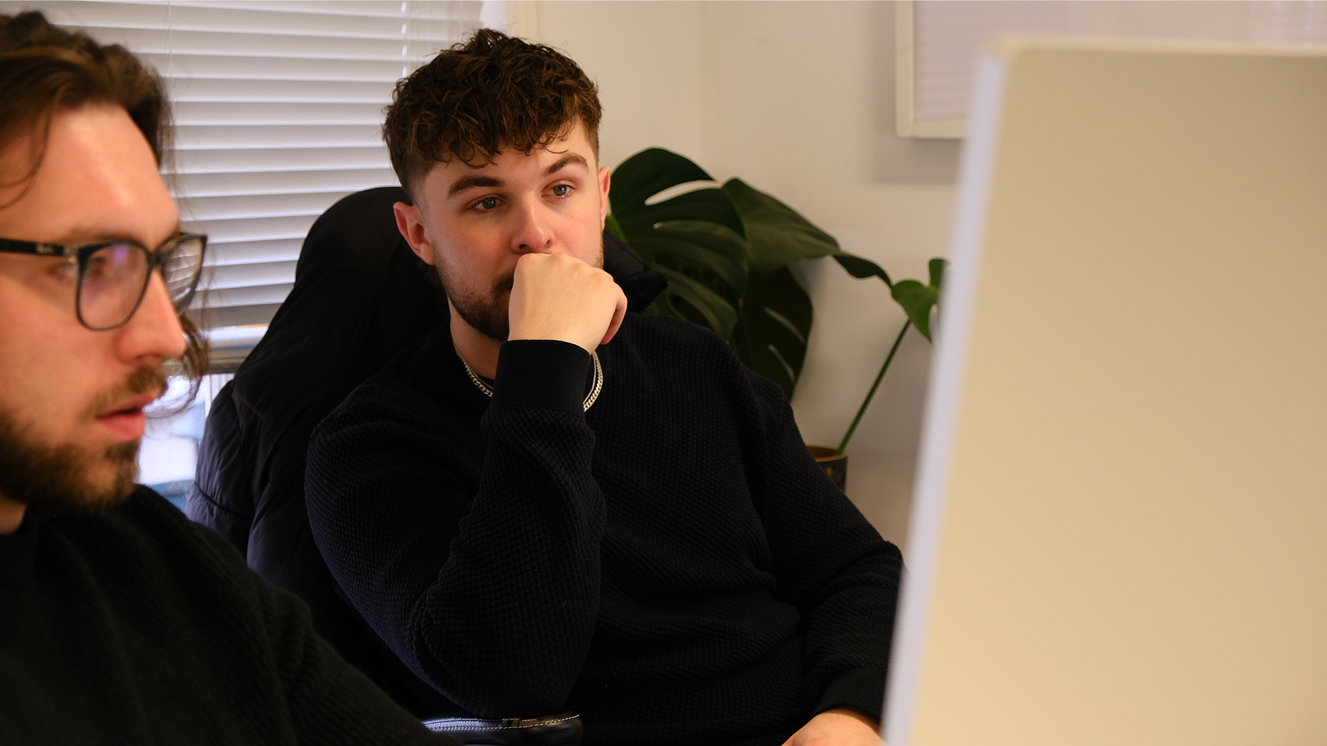 Two graphic designers working on brand design at computer